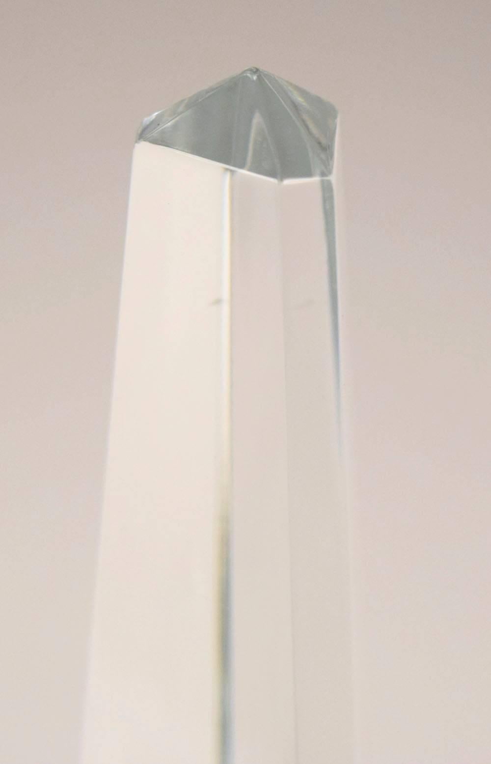 This stunning fine cut crystal obelisk is by Baccarat. It bears the Baccarat stamp and seal on the bottom. It is in incredible an in good condition.

Note: Has a small chip on one of the sides.