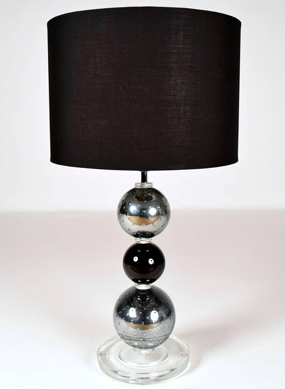 Beautiful pair of contemporary Italian Murano Lamps. Three sphere column with a round clear base. With black shade, newly wired in working condition.
Lamp with no harp and shade: 20