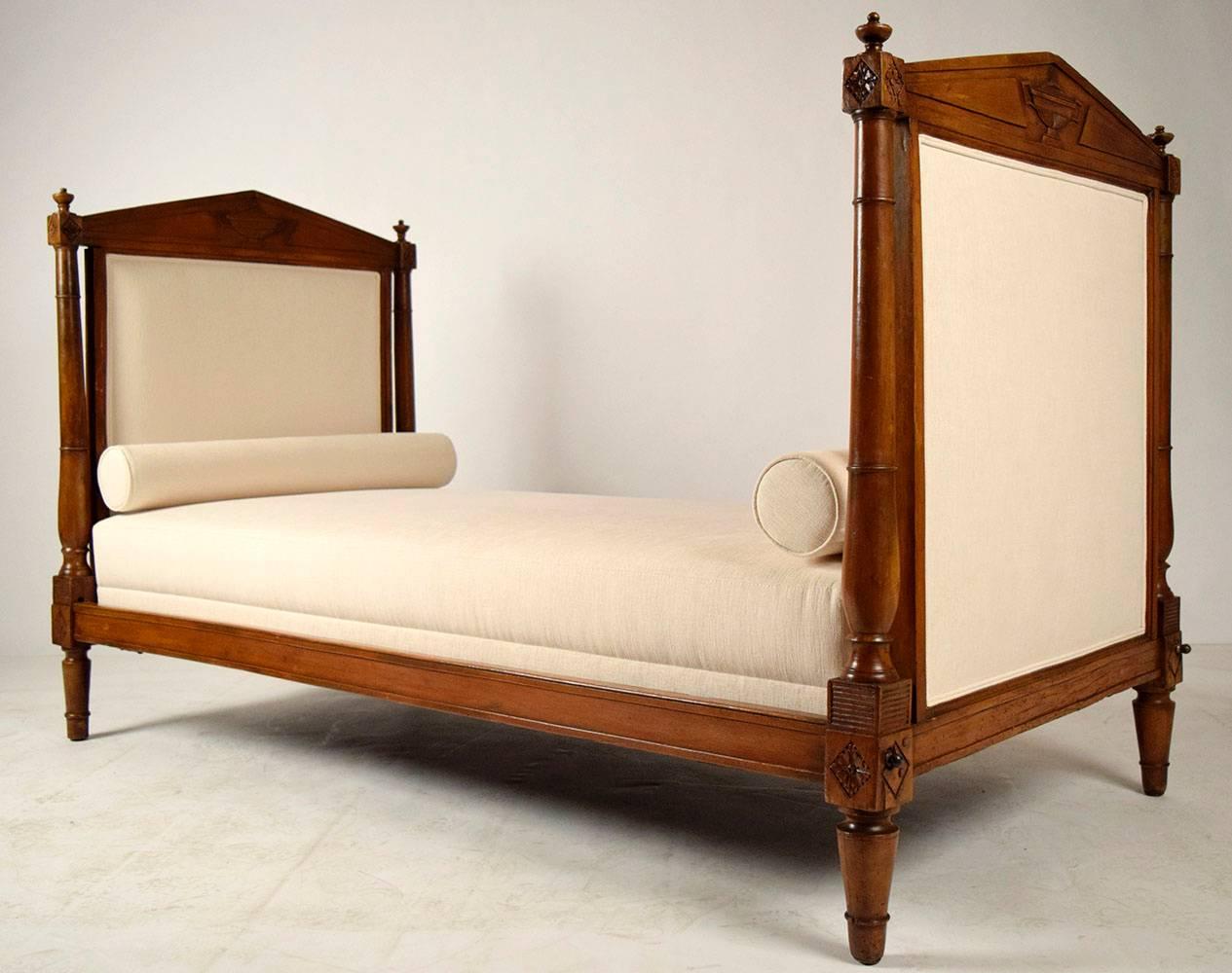 1860s mid-19th century Empire daybed. Walnut wood frame with original light walnut finish, showing beautiful patina. Headboard, headboards have been professionally upholstered in a ivory color fabric, comes with a new mattress and two booster