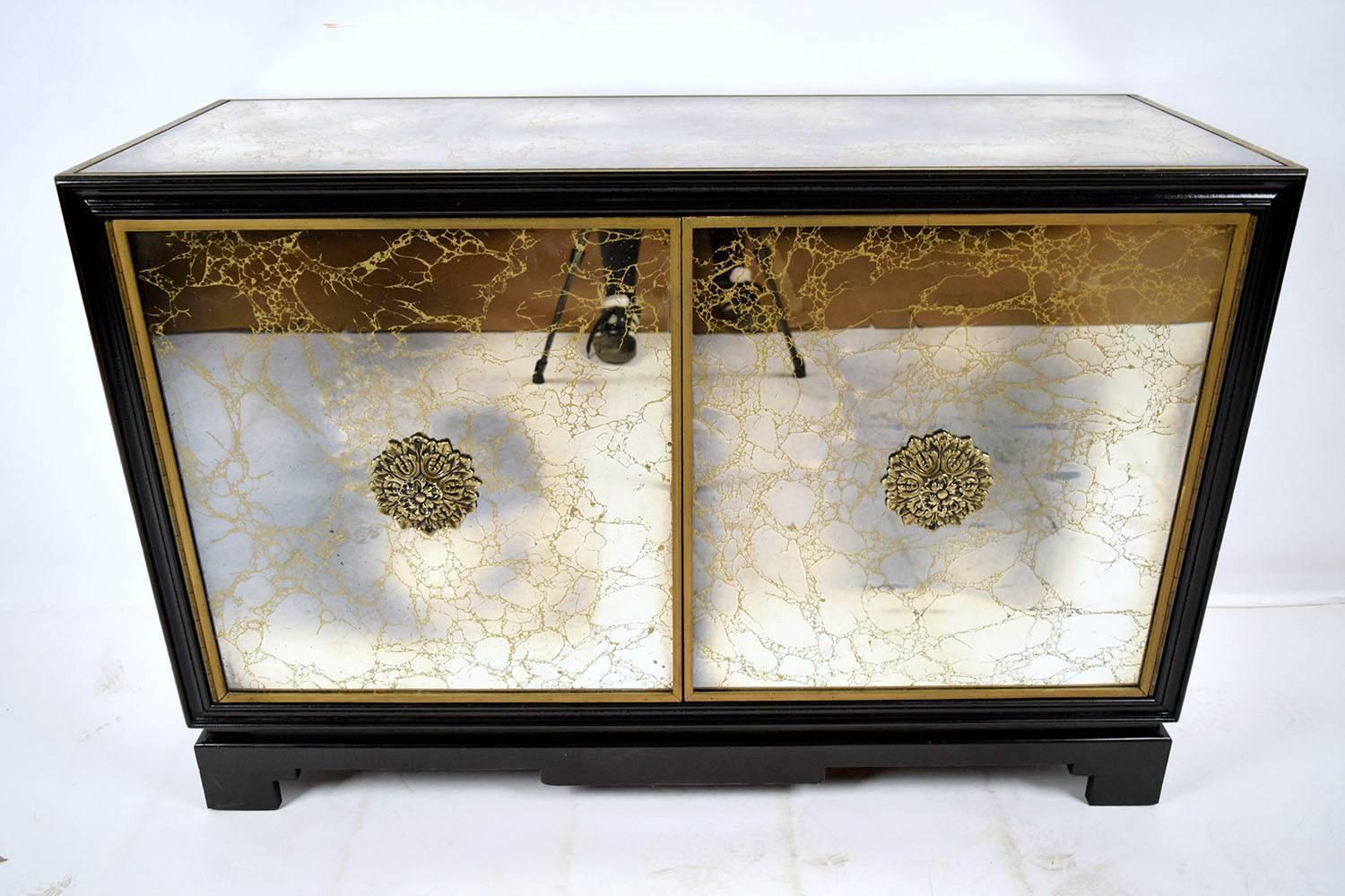 This is a beautiful modern sideboard. Made with solid wood, covered with elegant gold vein mirrors, finished with gold color mouldings around the top, sides and front. Newly finished in a deep rich black color. The two front doors have large brass
