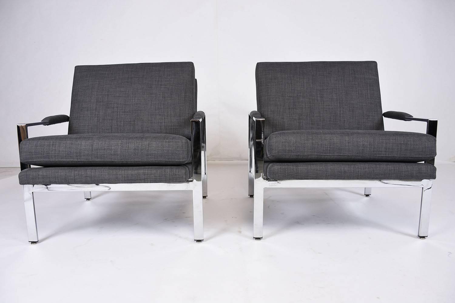 This 1970s Vintage pair of Mid-Century Modern-style lounge chairs are designed by Milo Baughman for Thayer Coggin. These stylish chairs feature minimalistic chromed steel frames with padded armrest. The comfortable seats have been professionally