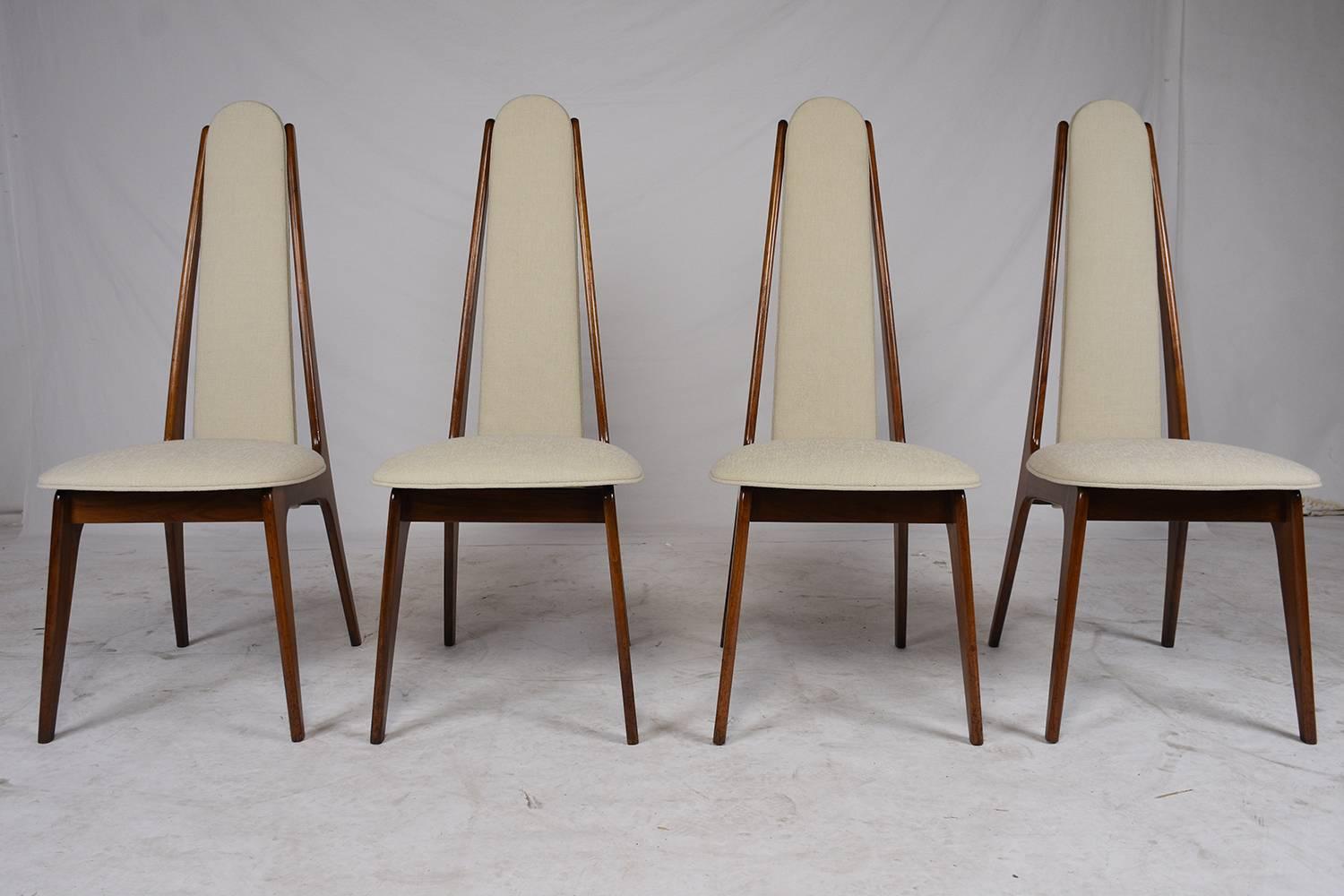 This 1960s Mid-Century Modern-style set of eight dining chairs are made in the manner of Adrian Pearsall and are very unique. With a slim profile the walnut frames have a slight curve and are very sturdy. The cushions have recently been