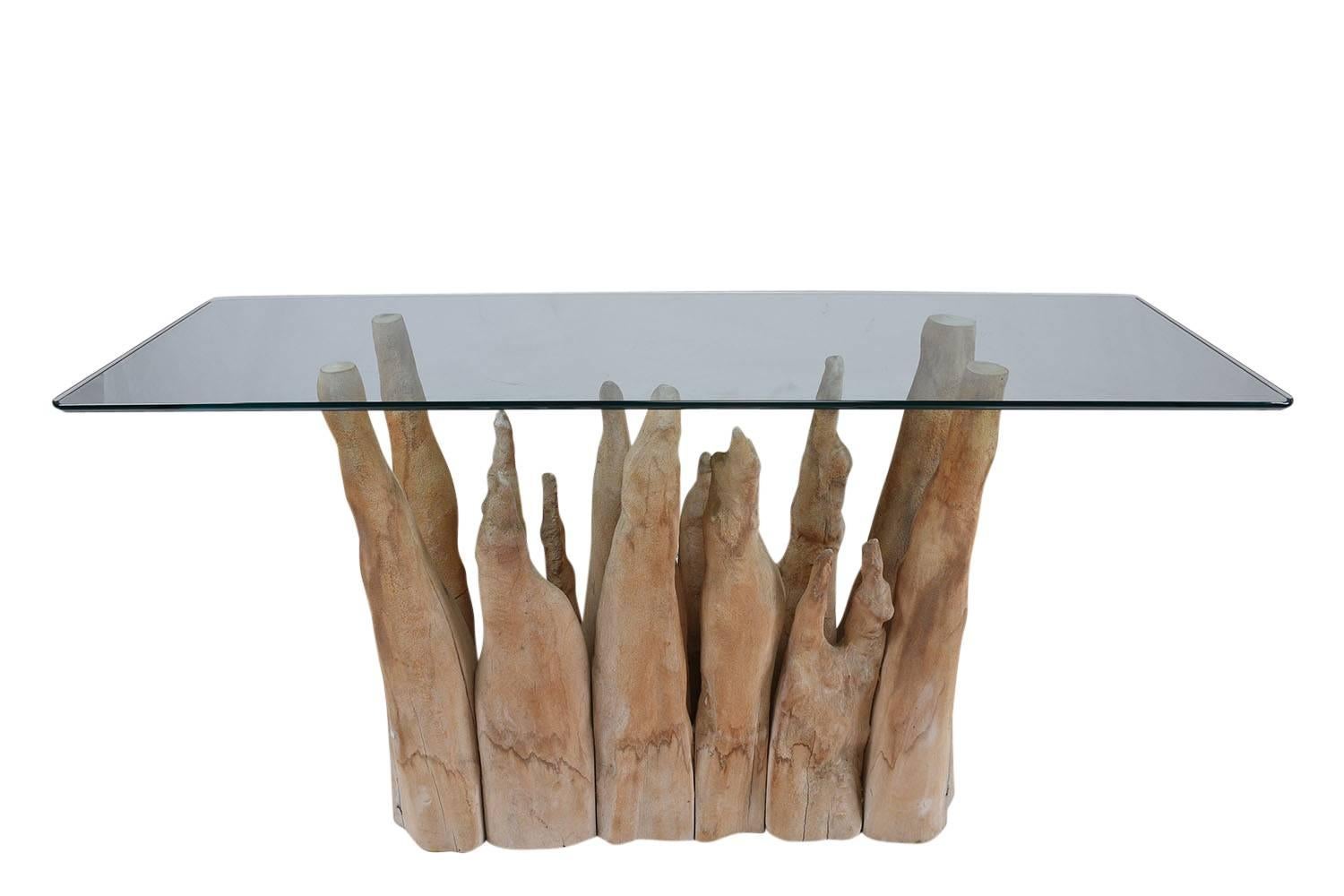 This 1970s vintage sofa table is made by Michael Taylor and is very unique with a natural wood base. The organic shaped tree branches form an eye-catching base that is both sturdy and contemporary. The top of the table is a clear glass top with an