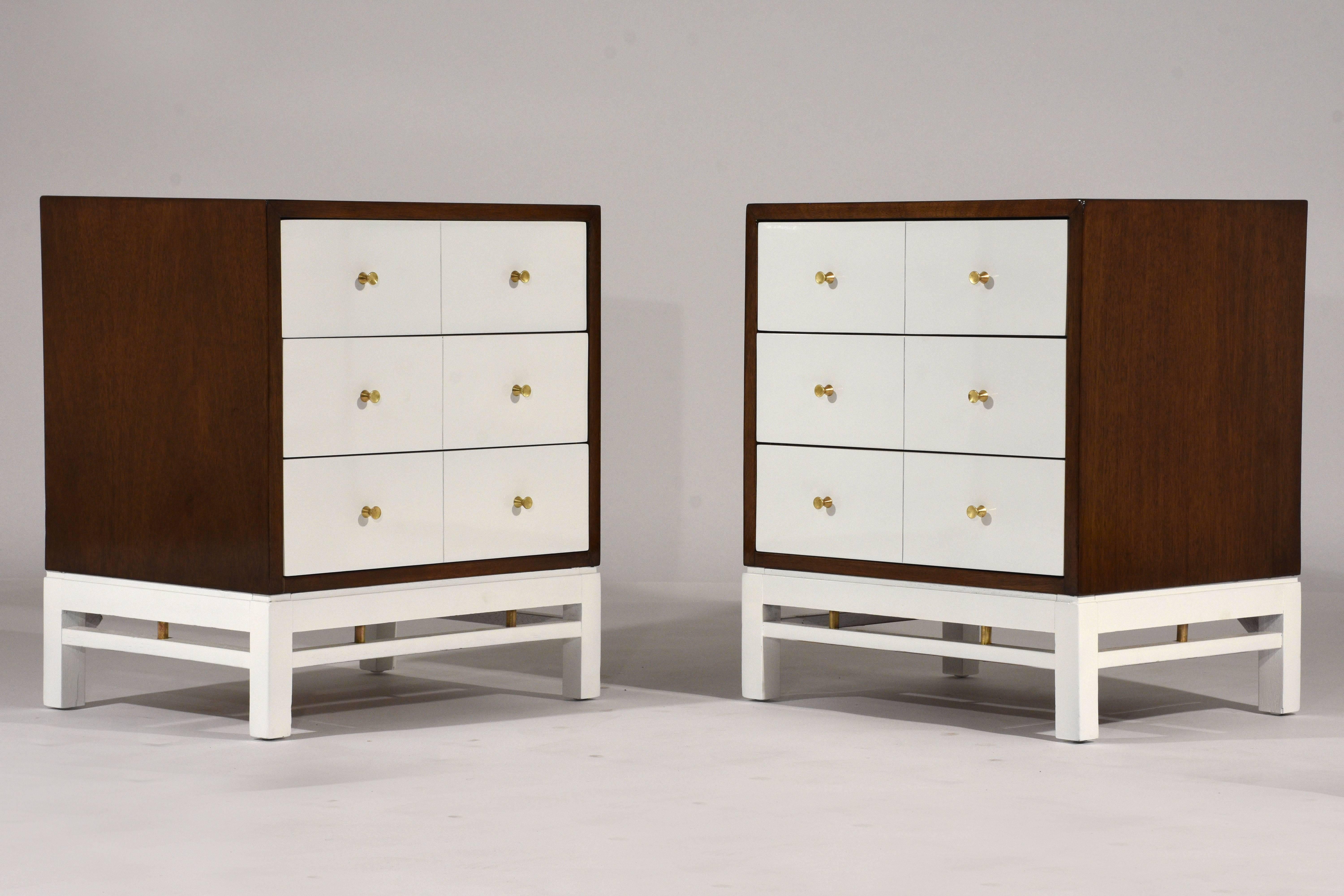 This pair of 1950s Mid-Century Modern-style side tables or nightstands are designed by Paul McCobb. The outside of the night stands are finished in a rich walnut color stain and the facade of the drawers and the base are finished in an off-white