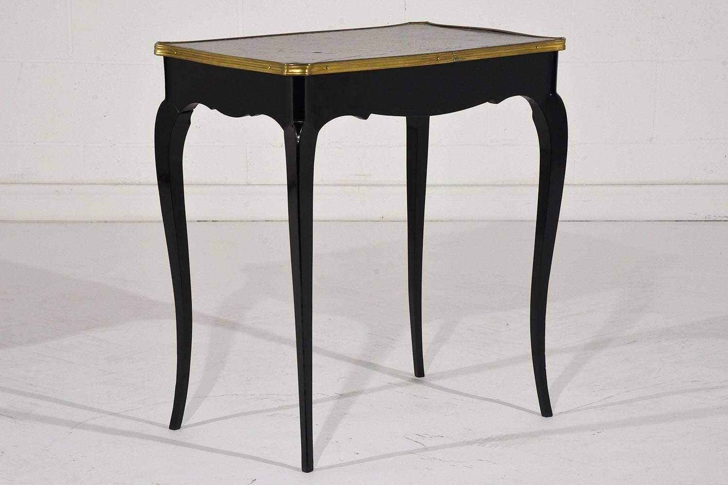 This pair of 1900s antique French, Louis XV style side tables are made from mahogany wood with an ebonized stain and a lacquered finish. The top features the original embossed cordova color leather top with a beautiful distressed finish. The edges