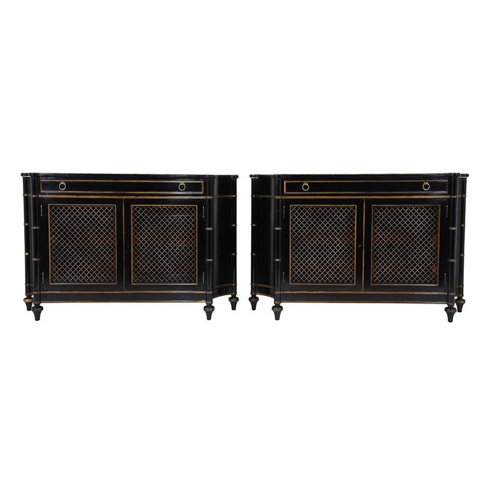 This pair of 1950s Hollywood Regency-style chest of drawers is made of wood ebonized in a deep black color and a lacquered finish. The curved sides create a unique and unexpected profile and accenting the corners are carved columns with bamboo-esque