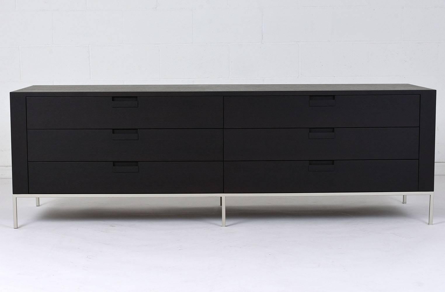 This 1980s Mid-Century Modern style chest of drawers is designed by Antonio Citterio for B&B Italia. The chest is made of teak wood ebonized in a rich black color with a flat finish. The six drawers have carved notches for drawer pulls and ample