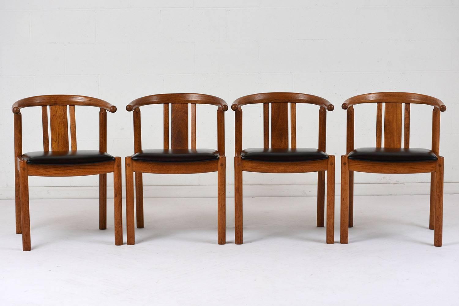 This Set of Four 1940s Danish Mid-Century Modern Style Dining Chairs feature sturdy teak wood frames stained in a walnut color with a newly lacquered finish. The frames have horseshoe back with a straight splat design, comfortable seats that have
