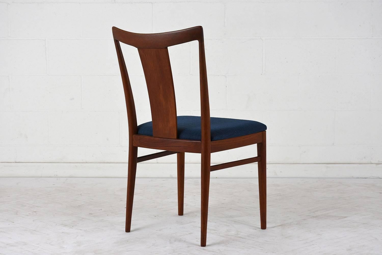This set of six 1960s Danish Mid-Century Modern style dining chairs are designed by Rasmus Solberg. The teak wood frames have been stained a dark walnut color with a lacquered finish. The seat backs are curved with a large splat in the centre and