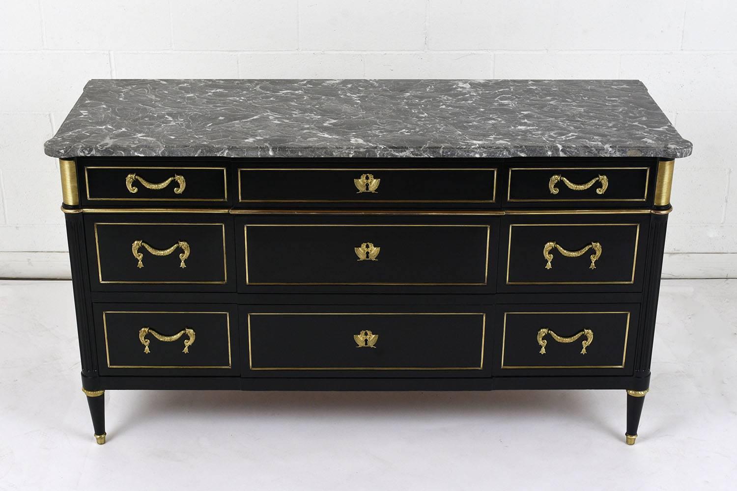 This 1900s, Maison Jansen buffet is made of mahogany wood with an ebonized and polished finish. The original marble top is a dark gray color with white veins and a beveled edge. The buffet has nine drawers in varying sizes with ample storage space.