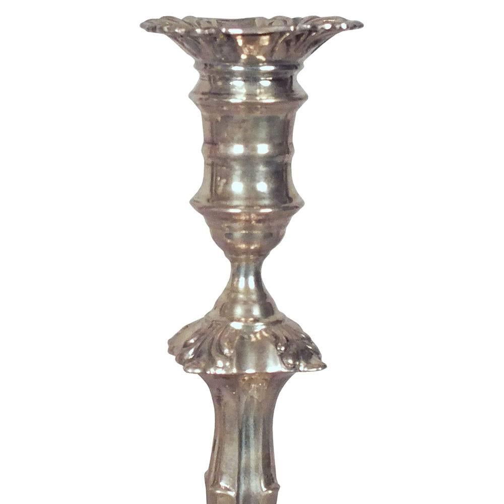 This pair of 1980s Vintage English candlesticks are made from Sterling Sliver. The candlesticks are beautifully decorated with floral motifs and decorative scrolls. Both candlesticks are in excellent condition. They are stamped 925 and weigh 7.973