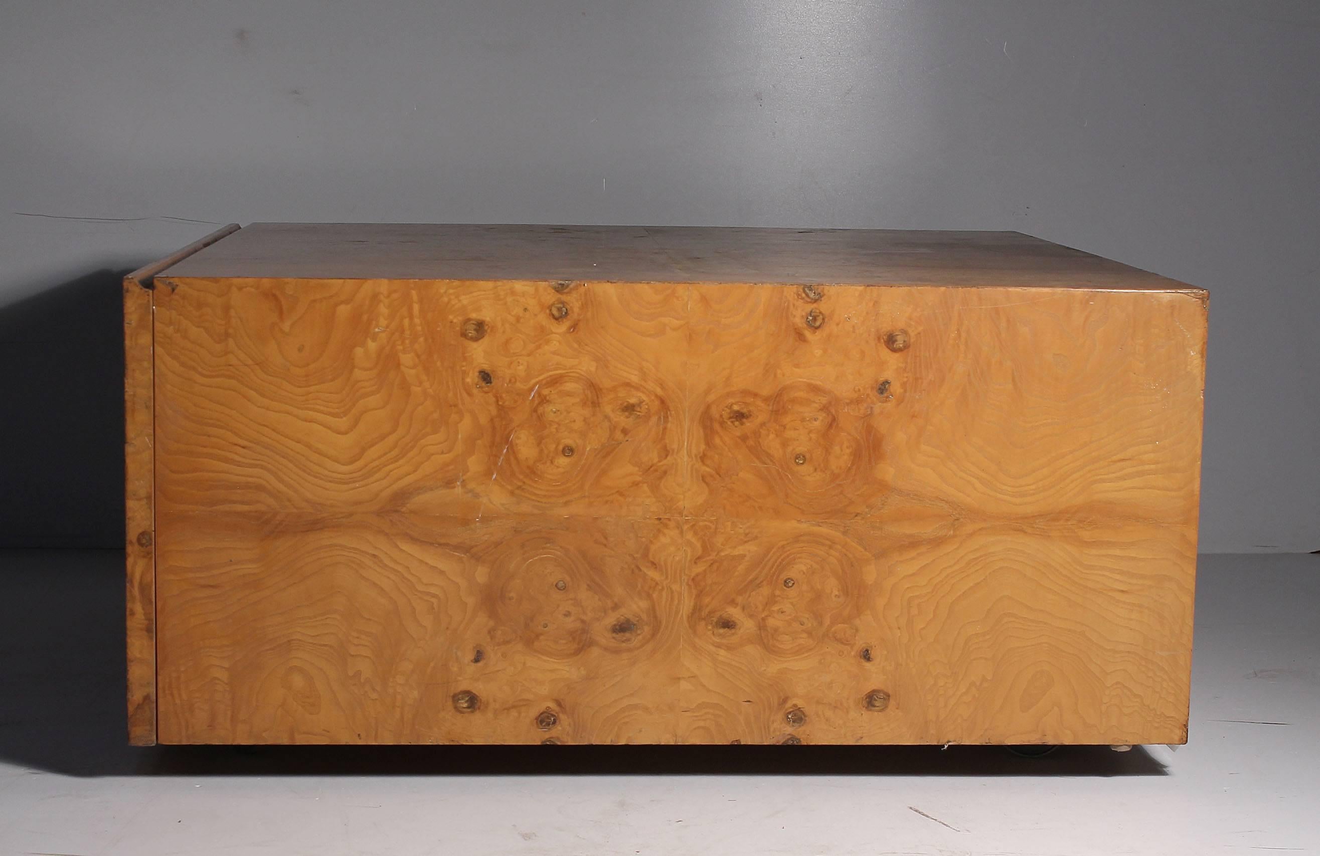 Milo Baughman burl wood coffee table on castors with large drawer.

This item does need to be refinished. Price is in as-is condition. This can be done here in Chicago if desired.