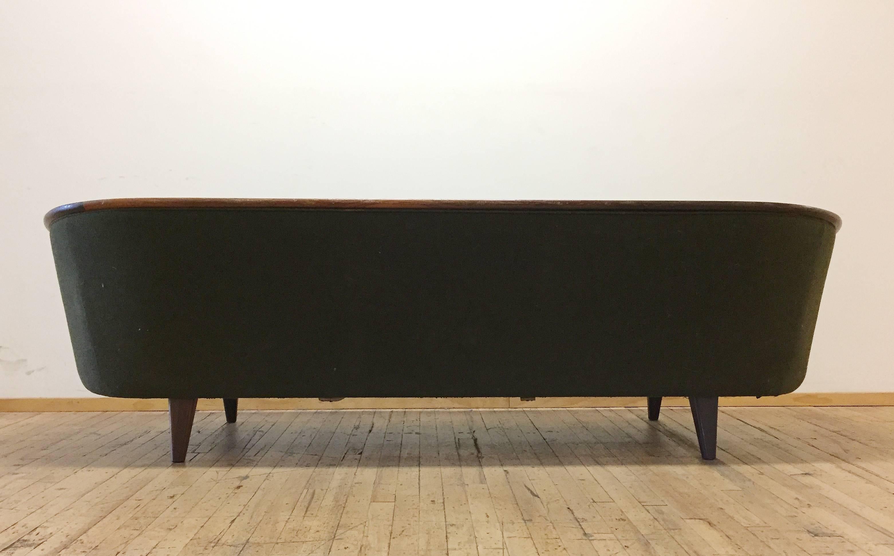 Beautiful and early P.I. Langlos Fabrikker, Stranda sofa design. I believe Rosewood legs and detailing. Design in the style of Illum Wikkelso.

Original early paper tag still attached on underside. Details the product number.

Following is