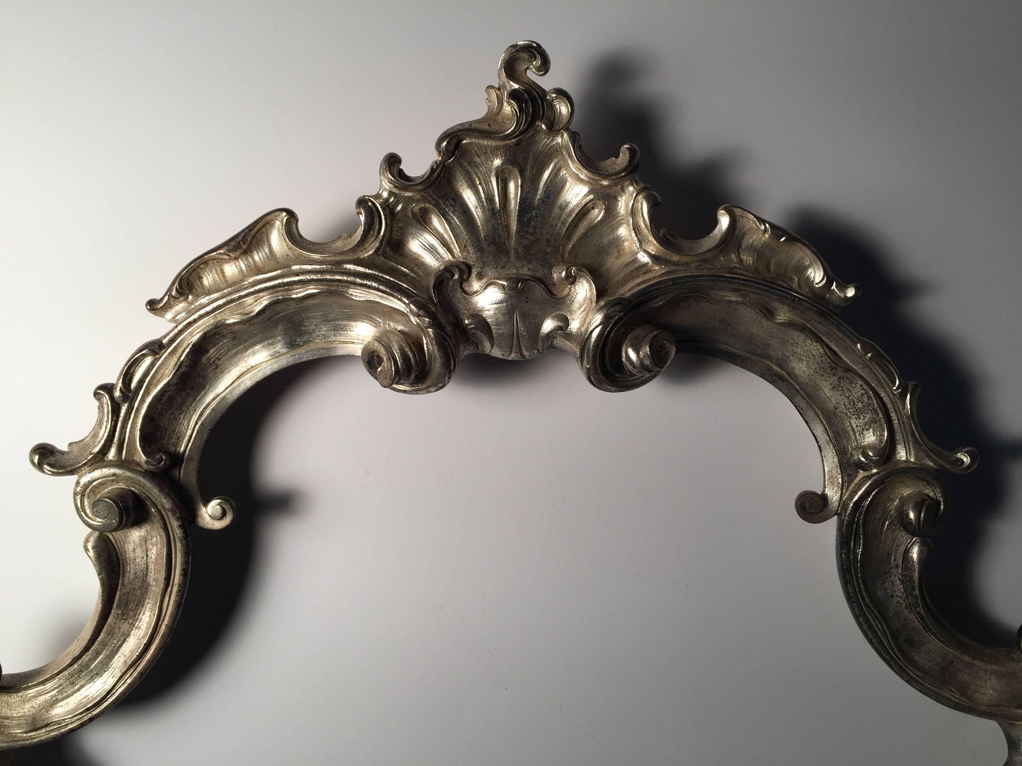 Hollywood Regency large Italian Rococo table mirror in silver metal

A vintage piece probably dating to the 1920s-1950s. Possibly earlier. Excellent quality of castings.

Please contact to review condition. Needs a minor repair with the easel back.