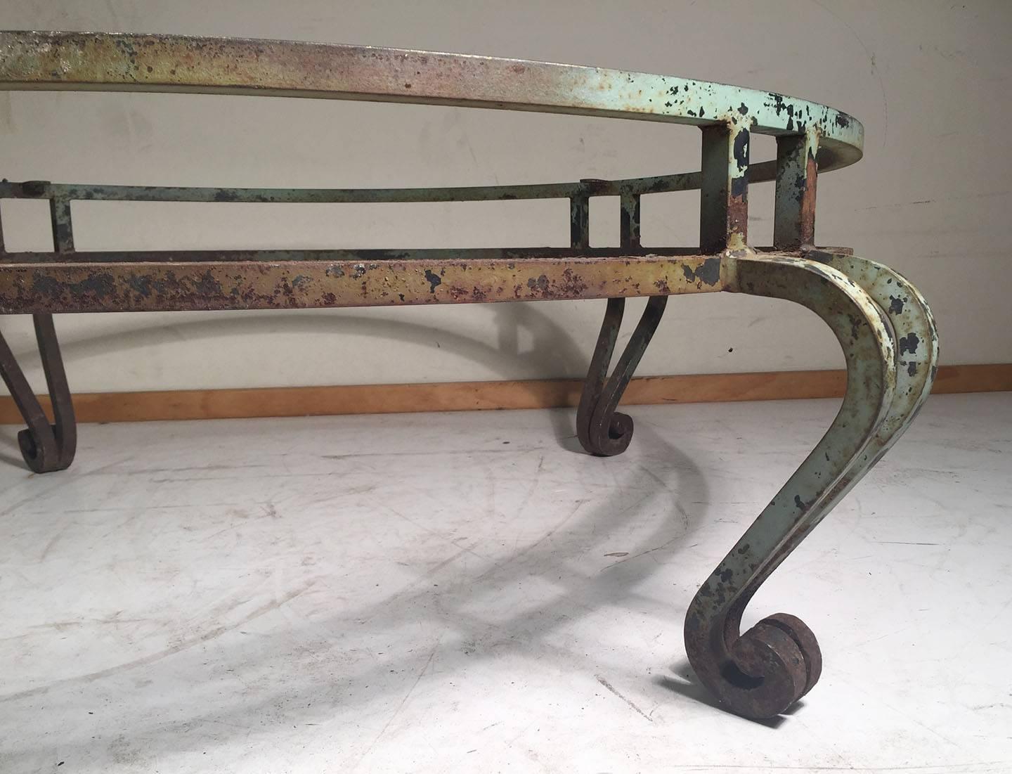 Probably gilded at one time this architectural wrought iron coffee table is great for an outdoor setting, or indoors. Either a fresh coat of paint, or gilding is most likely desired. Though some may prefer the distressed look as it is shown. 

No