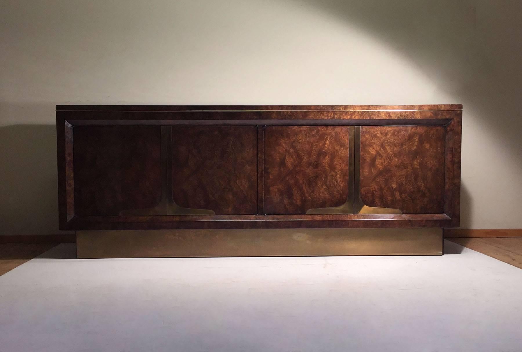 Beautiful Mastercraft sideboard cabinet credenza by William Doezema. Features a beautiful burl in a nice darkish finish. The brass on the pedestal base is attractive dark patina as shown.


In the manner of Milo Baughman and Karl Springer

A few