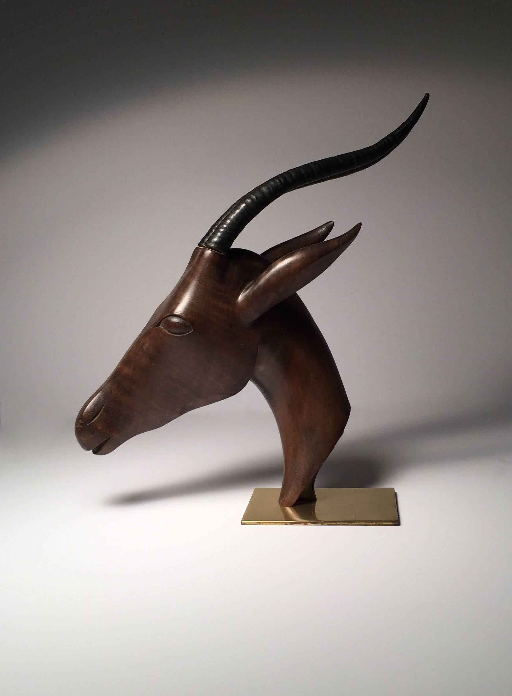 Large Hagenauer Gazelle (deer) wood and bronze sculpture
Beautifully designed brass base supporting an exotic wood form of a Gazelle.
Bronze horns attached to wood. A slight gap between where they mount and the wood. Not detracting in my opinion.