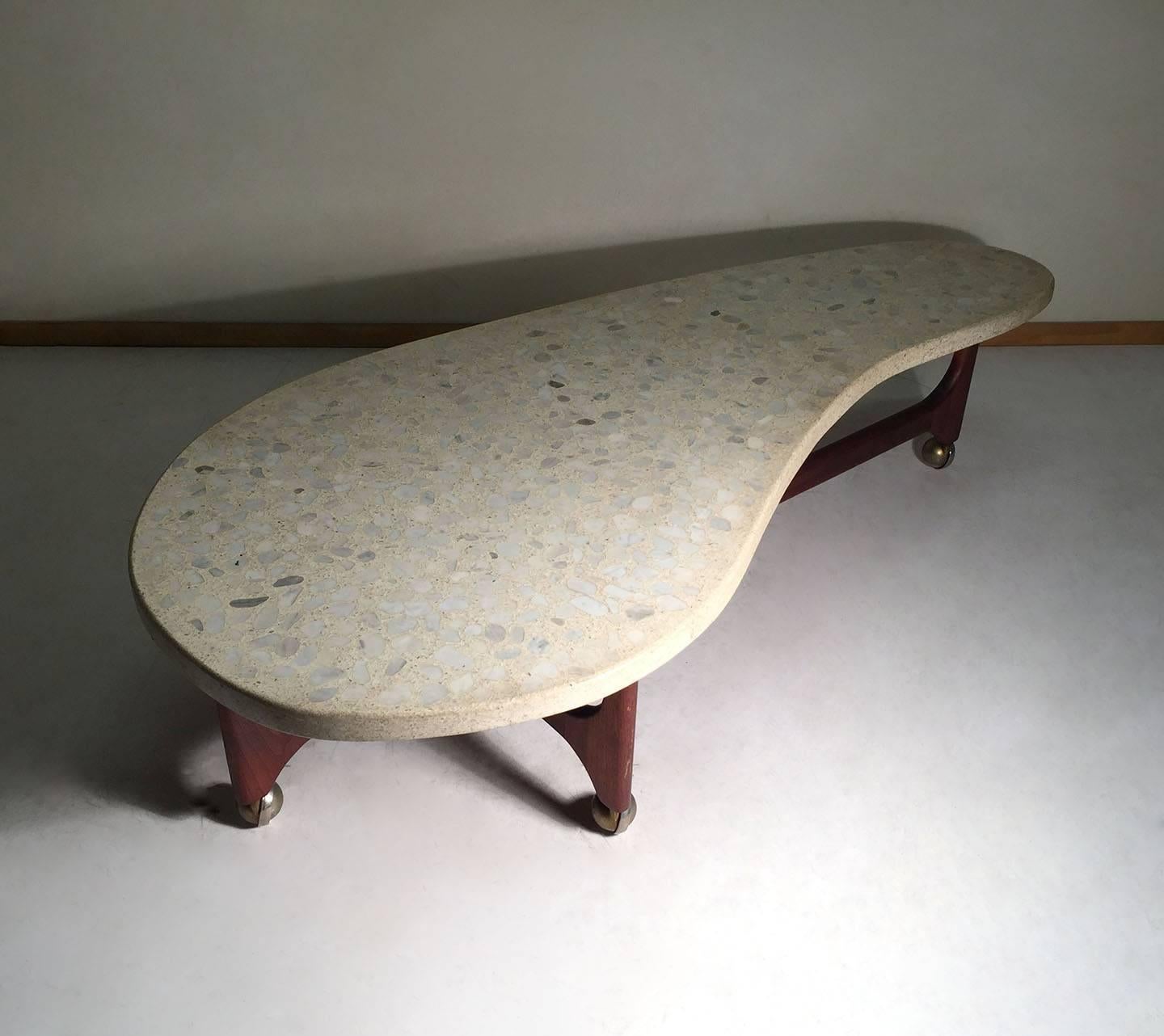 Rare cloud form Terrazzo coffee table on sculpted walnut base on castors. No identifying labels, however most dealers attribute this furniture line of work to Harvey Probber. Of the same period and style of Adrian Pearsall. More pics to come.