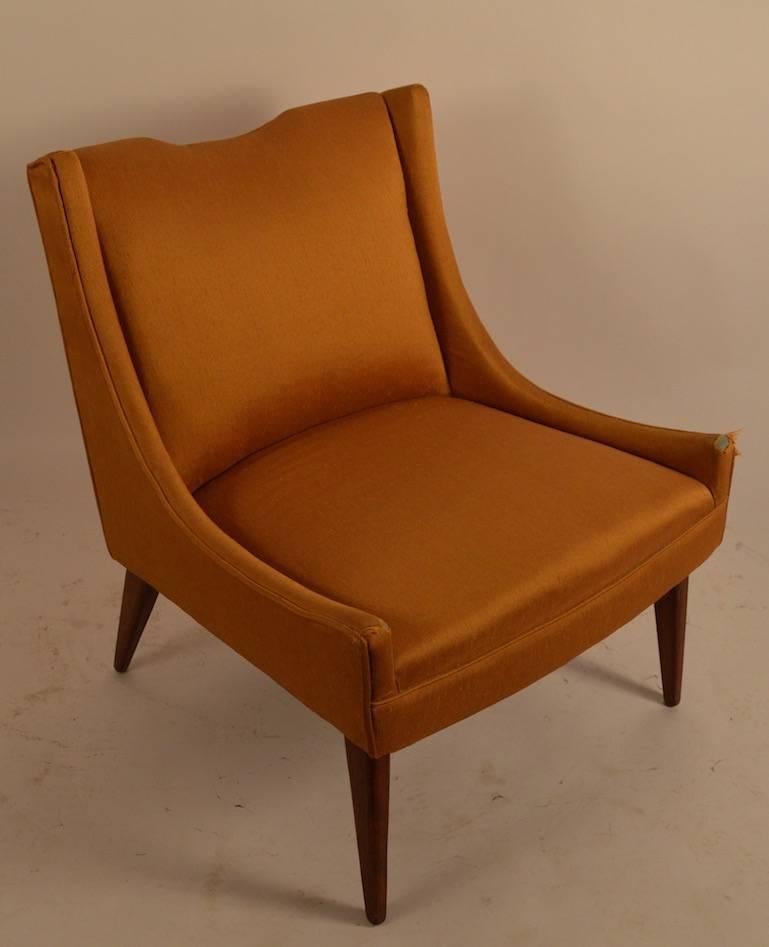 This stylish chair will need to be reupholstered, but the frame is solid and sturdy and the lines are excellent. Design by Harvey Probber.