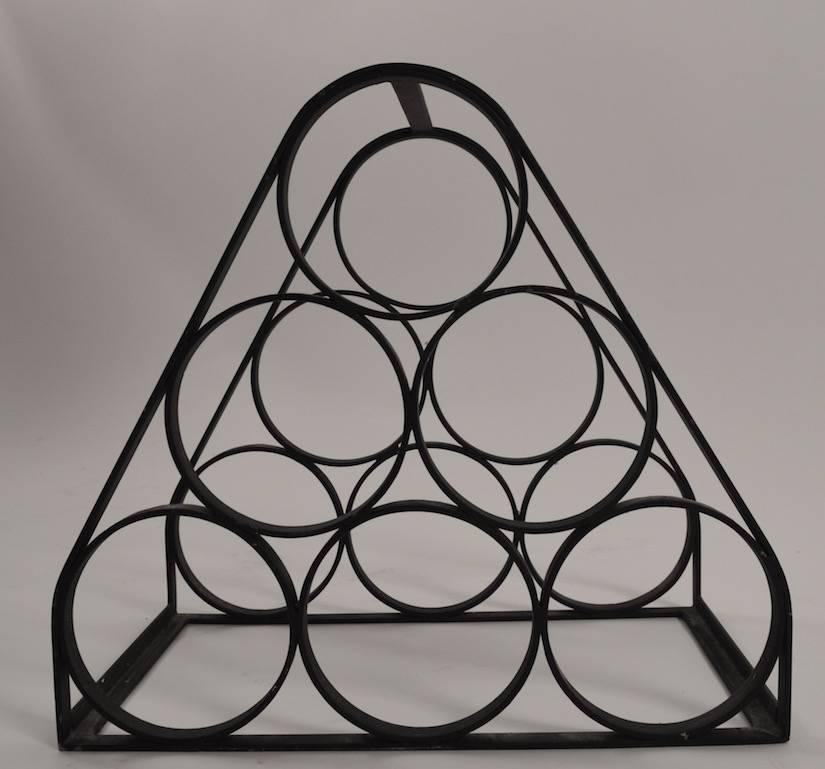 Pyramid shaped iron wine rack, in the style of Arthur Umanoff. Good heavy construction, well executed period item.