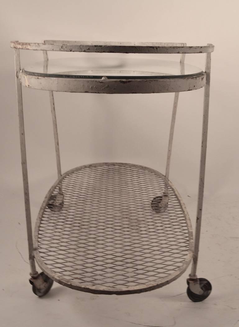 Woodard bar cart, metal frame with glass top. Currently in old white paint finish, and be powder coated or painted to taste or used as is.