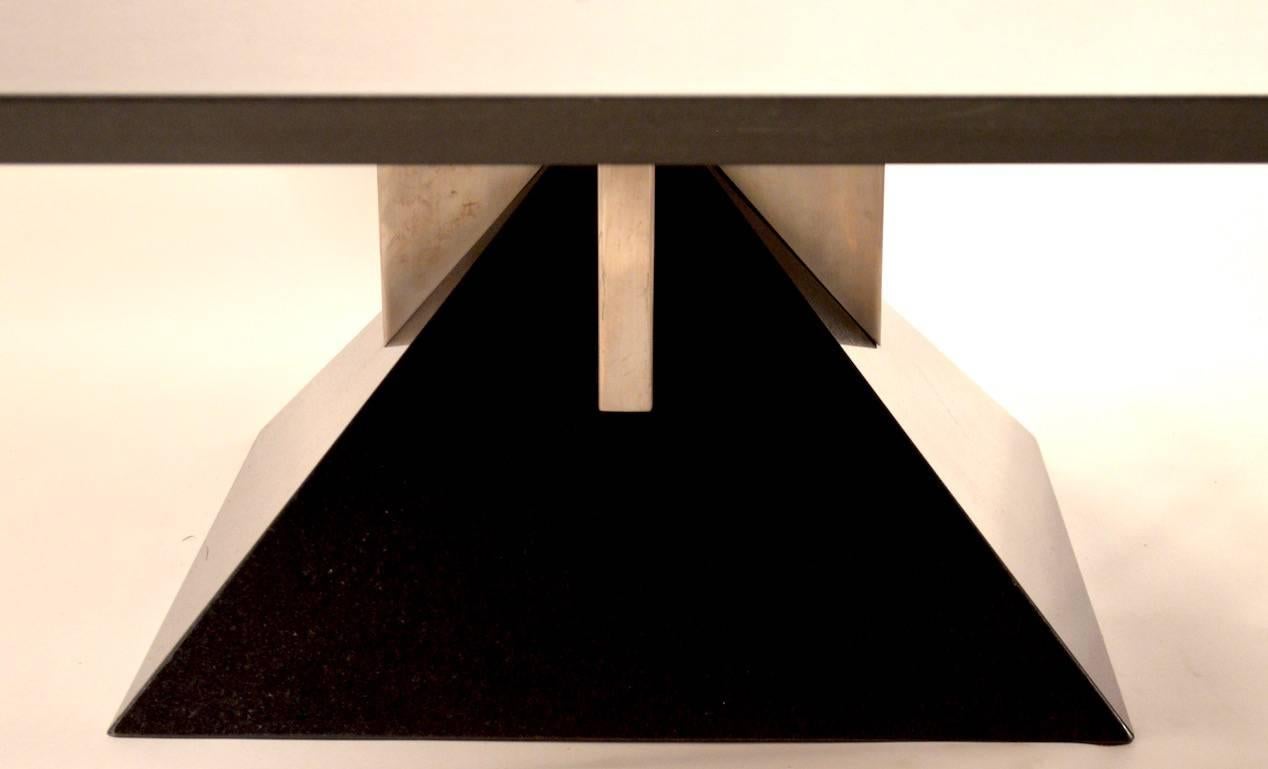 Classic 1980s Art Deco Revival square coffee table on polished granite pyramid base with brushed steel supports. Top quality design, materials and construction, excellent original condition (tiny repaired corned bottom foot, as shown,