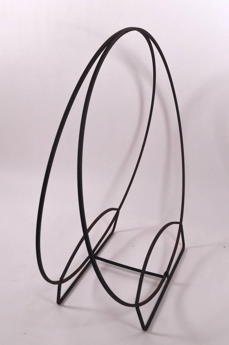 Nice large-scale wrought iron log holder, suitable for indoor or outdoor use. Unusual footed form base.