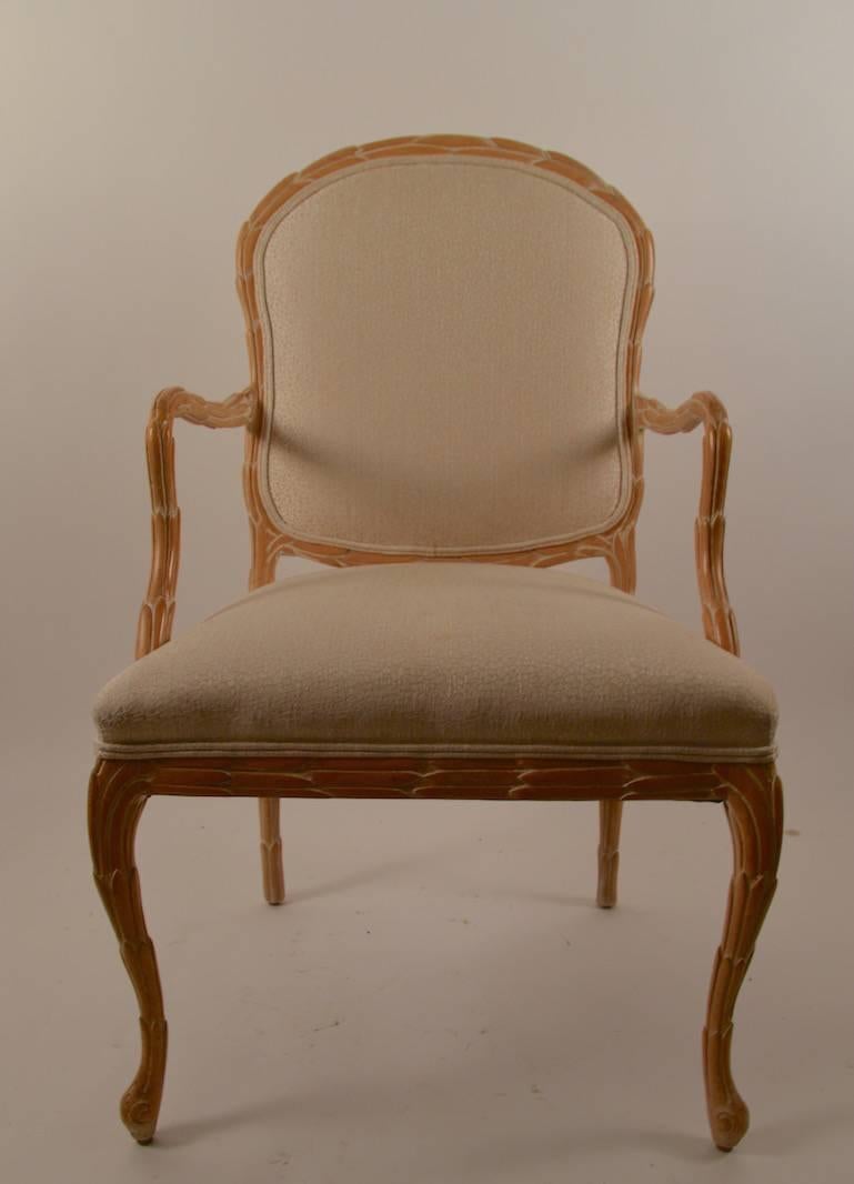Carved wood frame with upholstered seat and back. Retains original 