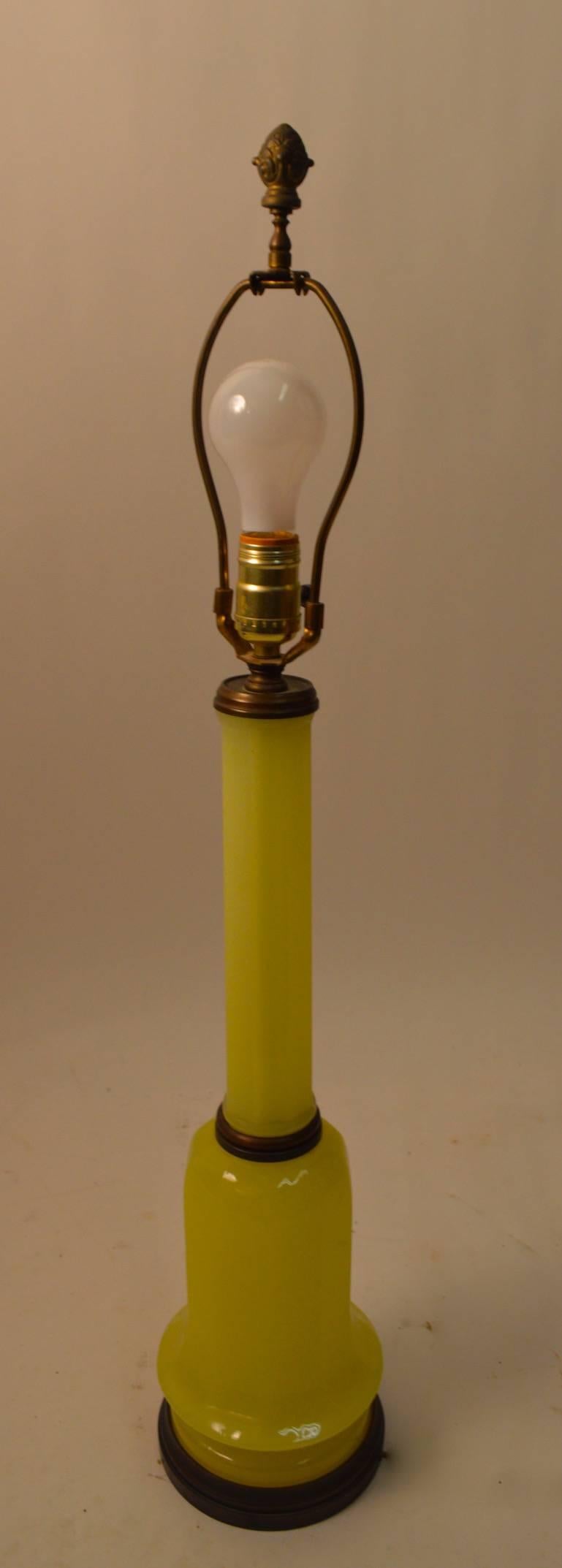 Elegant single glass lamp attributed to Paul Hanson, in yellow glass with brass trim. Original, working condition, shade not included. Height to top of socket 24.5