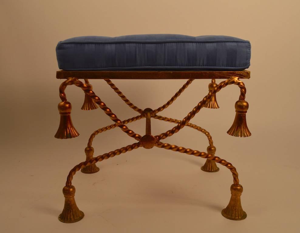 Twisted metal legs with decorative metal tassels and original upholstered tufted seat cushion. Upholstered pad seat is removable if you prefer the metal mesh surface. (Measures: H without cushion 16