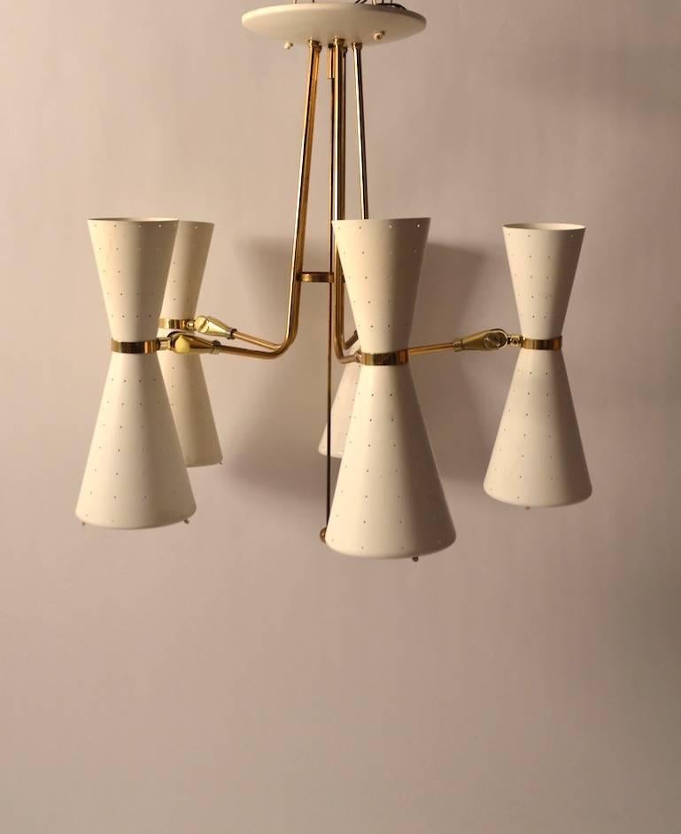Brass arms support the white waisted form lights. Each light cone can be illuminated with the up light and or the down light on or off. Each cone can be tilted and swiveled to adjust direction of light. Shades 4'- d at top x 5