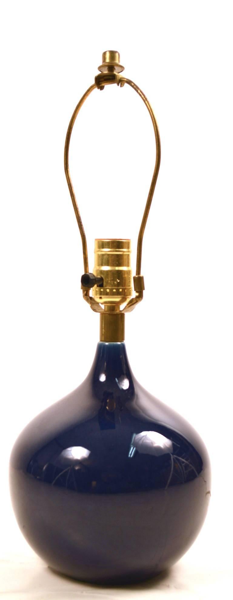 Deep blue glaze taeardrop form ceramic lamp by Lotte Bostlund. Clean, original, working condition, includes original shade. Height to top of socket 11
