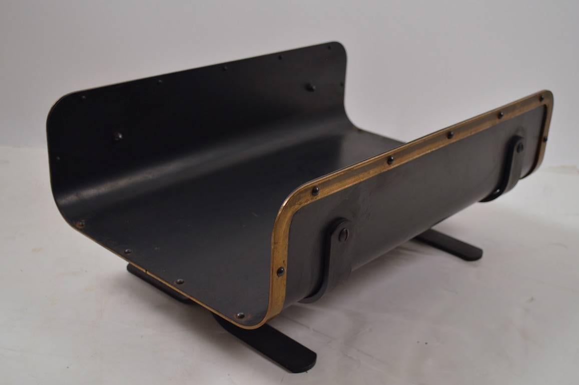 Mid-Century architectural log holder. Very good quality design and construction, Black steel with brass trim. Slight wear to finish, normal and consistent with age.