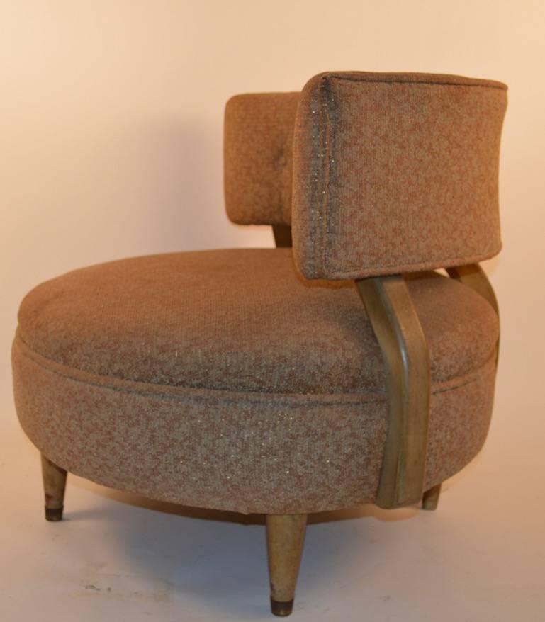 Stylish armless club chair with wrap around backrest. This chair will need to be reupholstered, but is structurally sound, solid and sturdy. The back leg is missing the brass sabot, not a difficult fix. Probably Kroehler manufacture, however it is