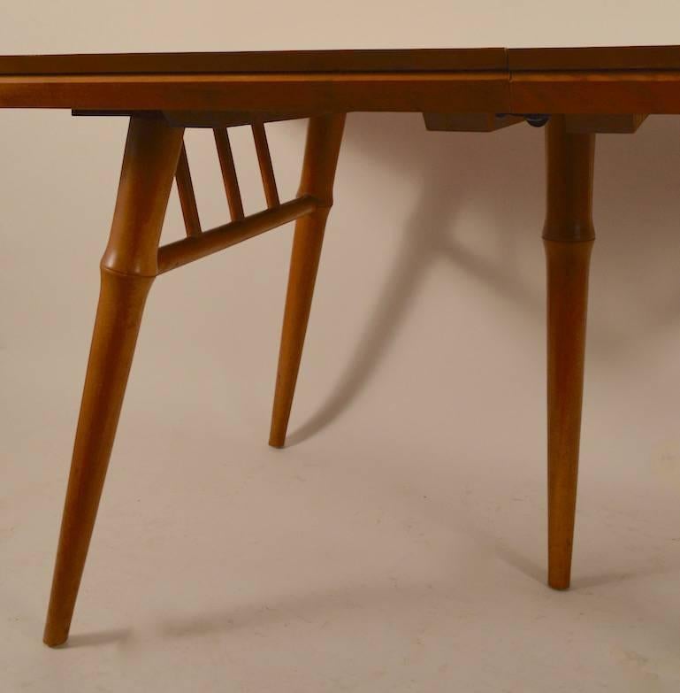Large dining table designed by Russel Wright for Conant Ball Furniture. This Classic table comes with three large (13.25
