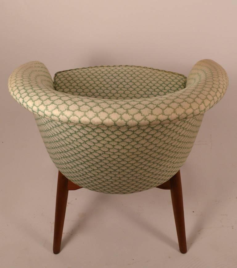 Danish modern tub chair, attributed to DUX. Upholstered top, teak legs and stretchers. The fabric shows overall wear, and should be replaced.