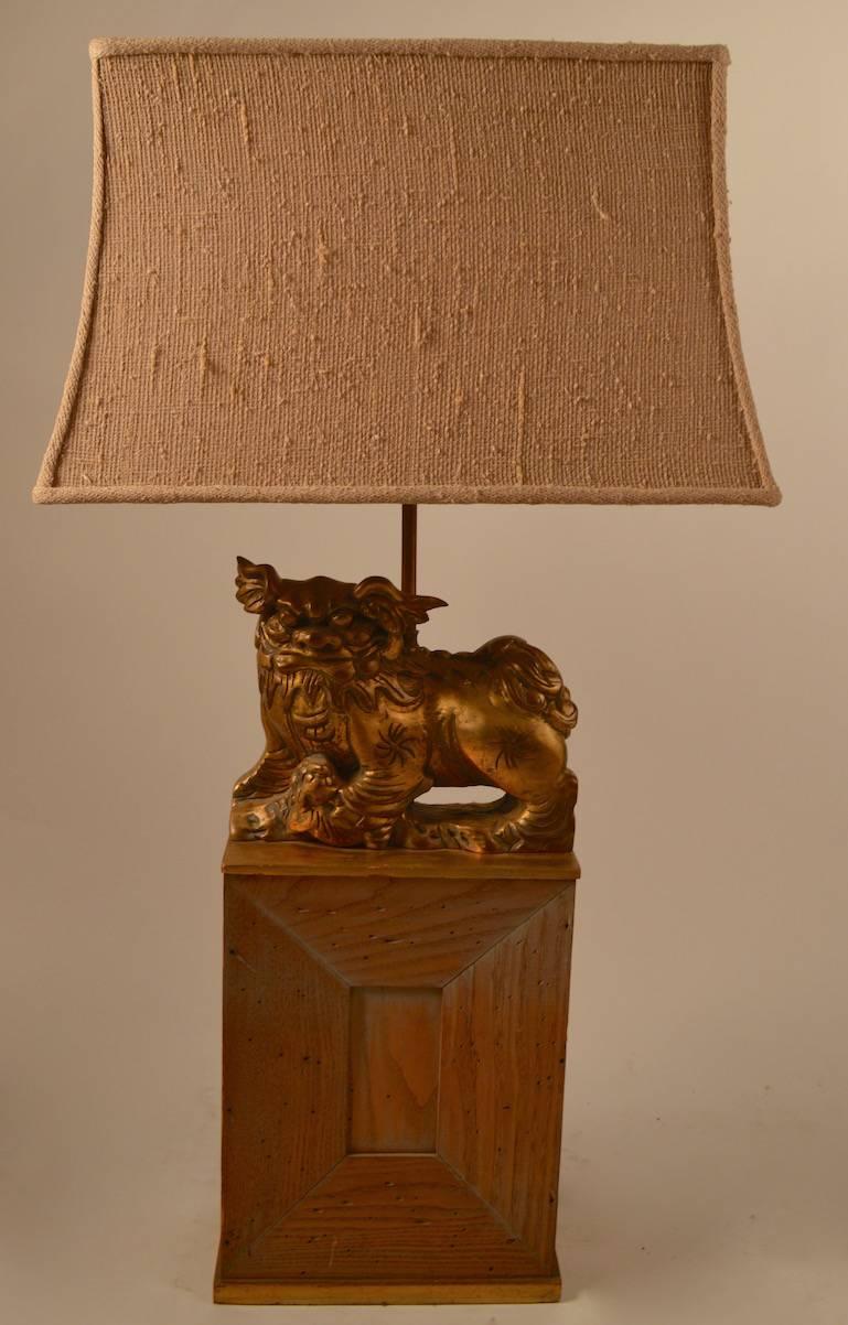 Great pair of Mont lamps, gilt foo dogs, mounted on cerused oak bases. These lamps include the original shades, shades show minor wear.
Both lamps are in very fine original, working condition, one lamp has a minor chip on the bottom of the base, as