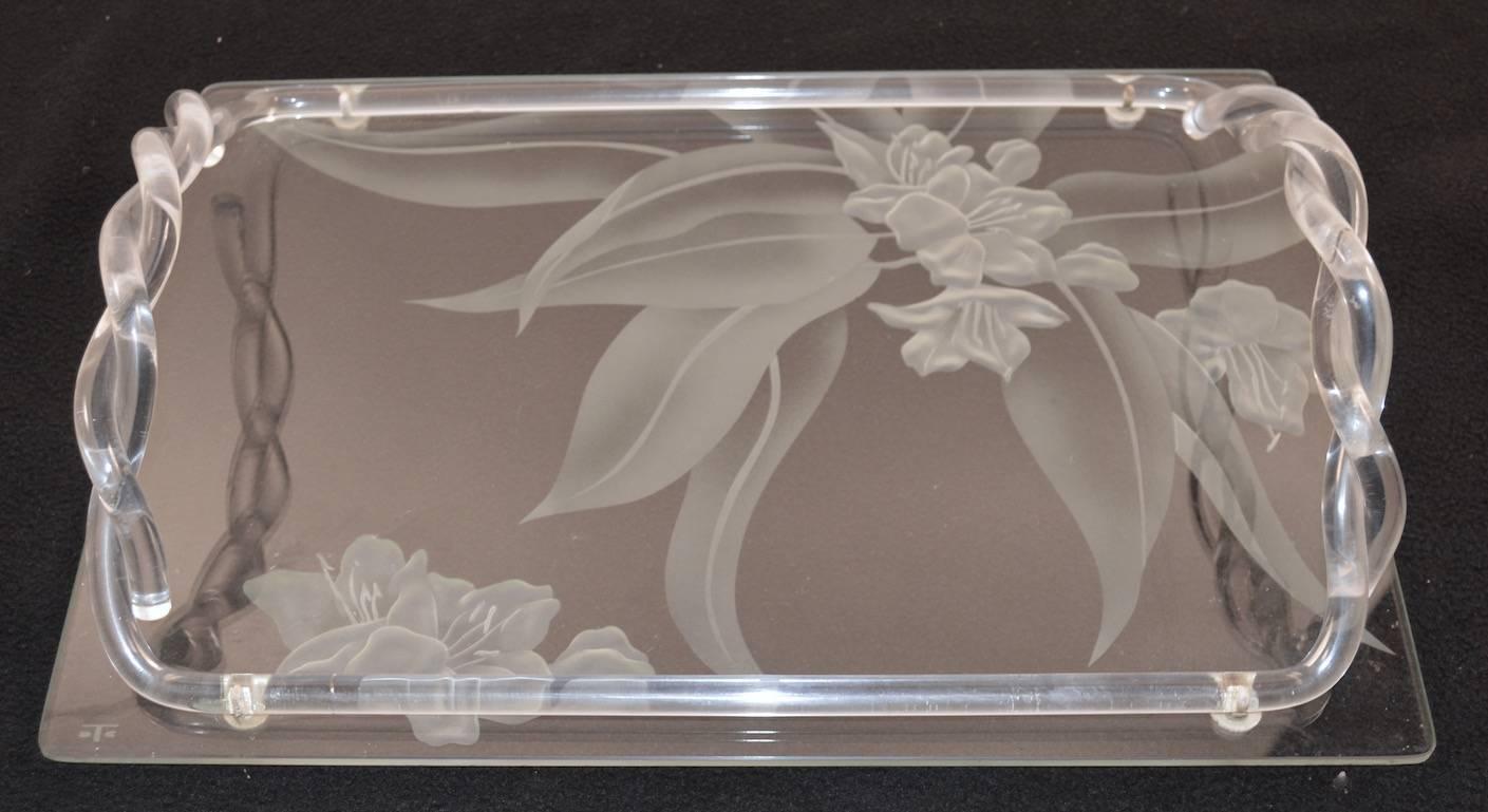 Art Deco serving tray by Dorothy Thorpe. The tray has signature etched floral motif, with rope twist Lucite handles. Excellent original condition, marked with the Thorpe cartouche.