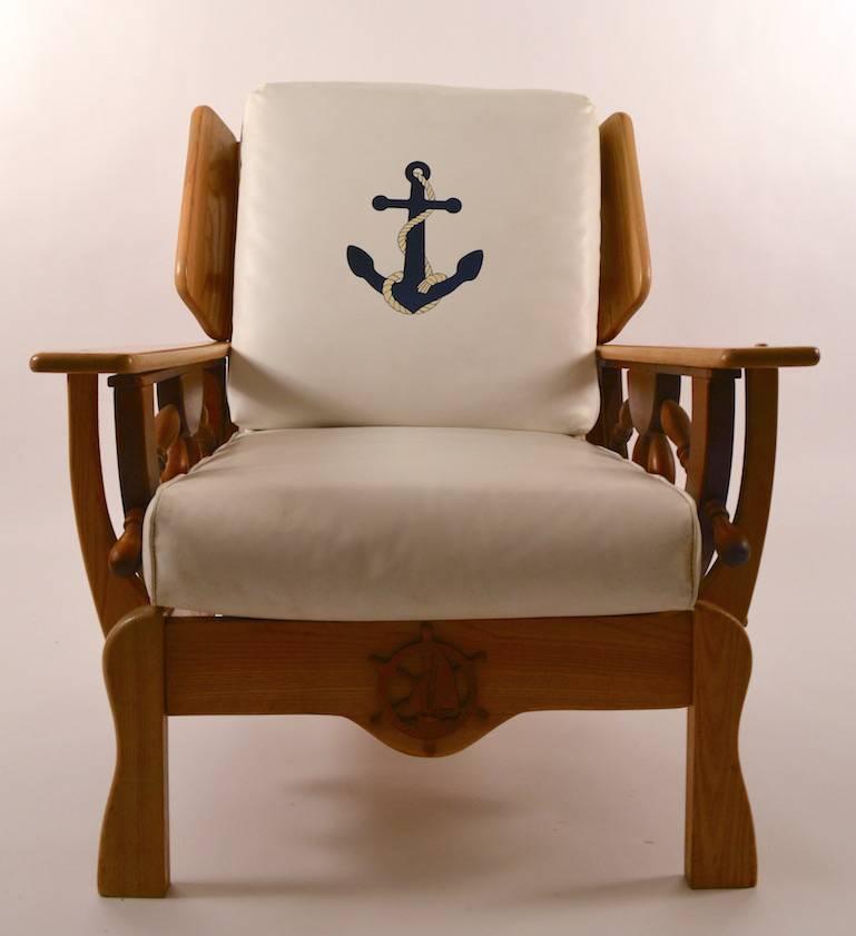Wood frame with loose vinyl cushions, nautical theme lounge chair. This chair has an anchor decorated back cushion, and ships wheel arm supports, as shown.
 Overall excellent, original condition, missing some of the wood caps, normal and consistent
