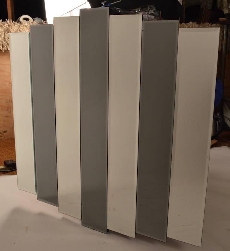 Dark grey (Darker than the pictures) mirrored panels alternate with clear mirrored panels which graduate in size. Art Deco revival Hollywood Regency period mirror. Ready to hang.