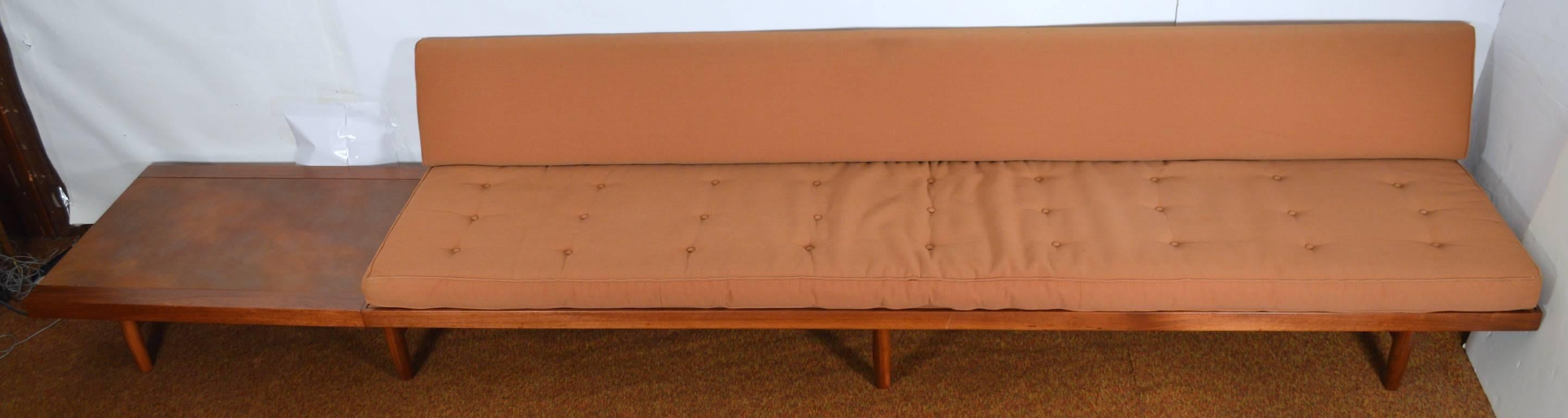 Great sofa, bench, with table surface at end, custom designed by architect. Fine craftsmanship, solid walnut with original fabric, usable but shows some wear. Measures: Length of end surface 42