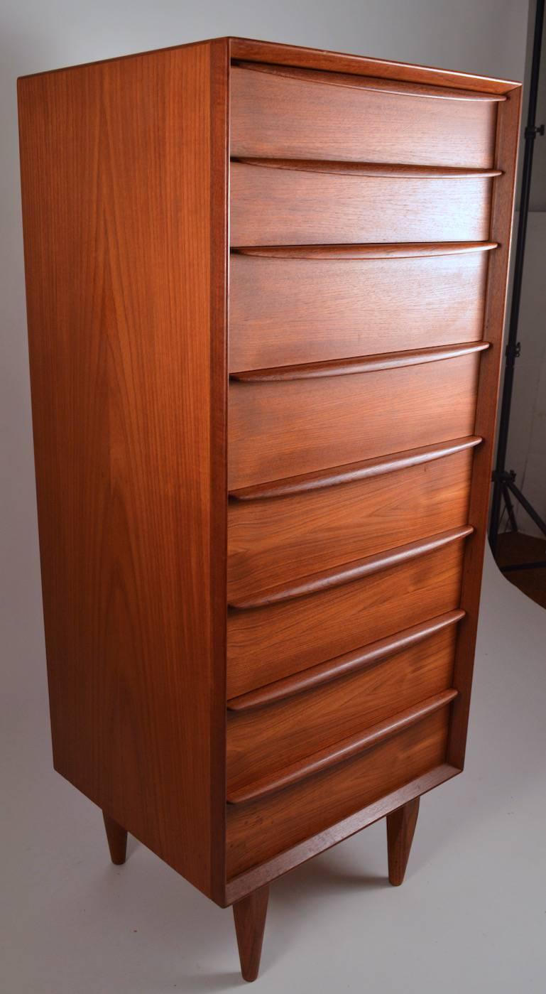 Tall and narrow eight-drawer chest by Falster, in teak. Danish modern style lingerie chest, hard to find form, not often seen. Clean, original condition, ready to use.