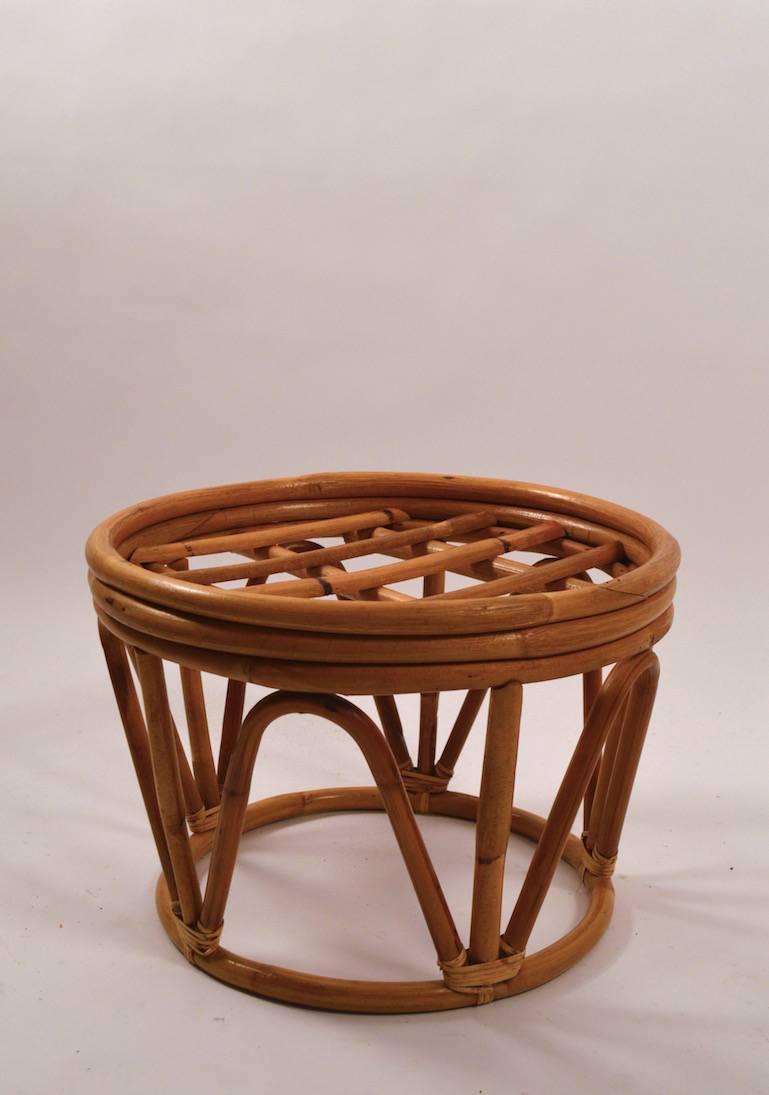 Nice circular bamboo footrest, ottoman. Comes with upholstered pad top, in black fabric. Measures: Diameter at top 19