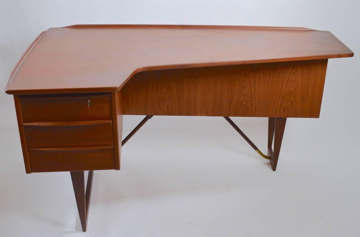 Nice Peter Lovig Nielsen desk in clean original condition. This desk has a locking top drawer and a locking mirrored case on the front.
 