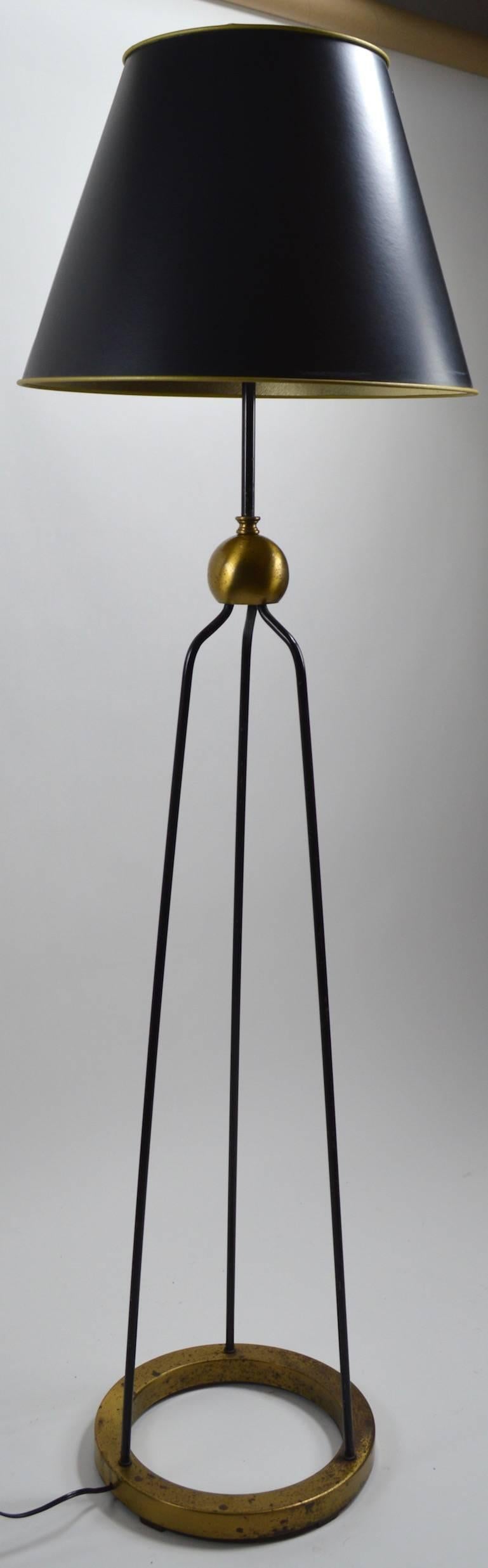 Gerald Thurston design for Lightolier Mid-Century floor lamp. Three iron rods with brass ball centre joint and single iron rod top. This example shows cosmetic wear to the finish, as shown, it has been recently professionally rewired and is in