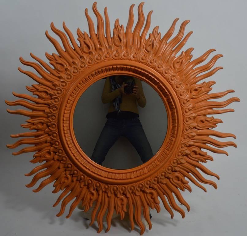 Large sunburst mirror with dramatic circular frame. The frame has been painted as shown. Diameter of mirror without frame 18" x 3" projection.
 