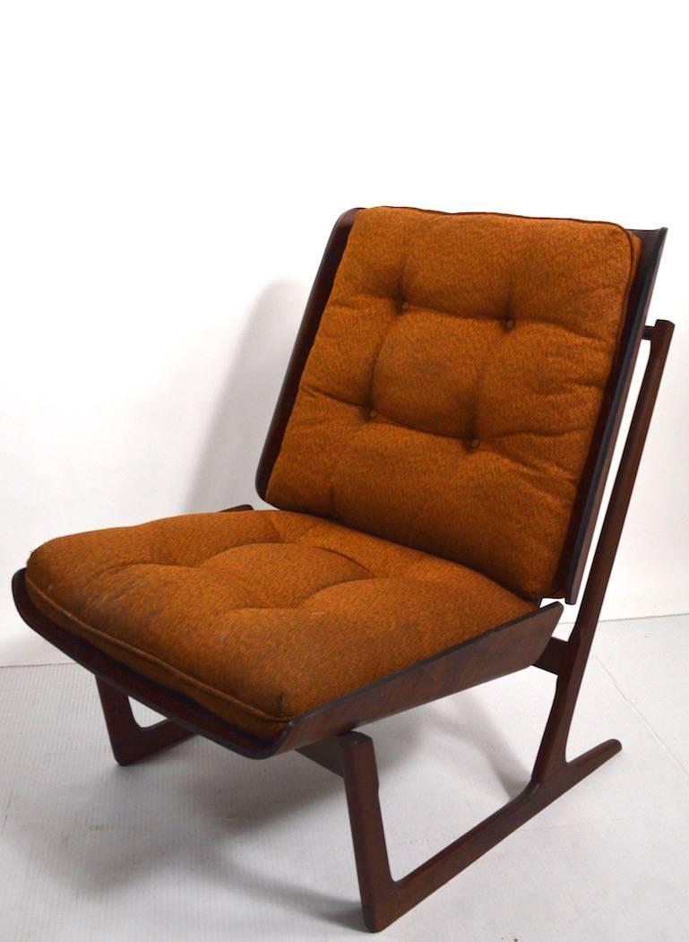 Sophisticated bent plywood lounge chair, wood frame with loose cushion seat and back. The cushions are original, but show significant wear and will need to be replaced. The frame is in great original condition. We have seen this chair attributed to