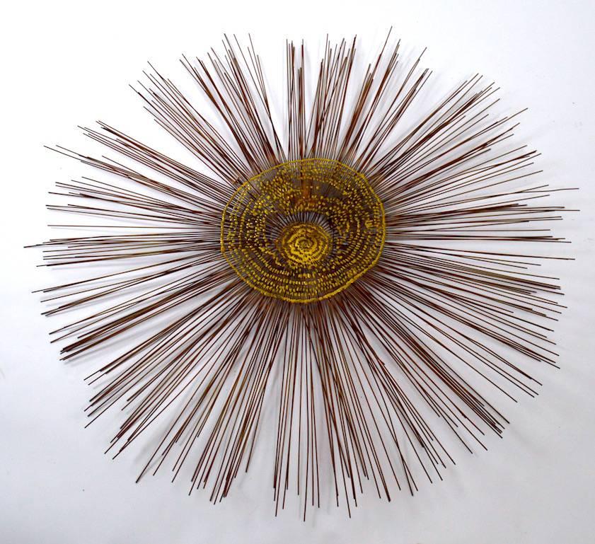 Period 1970s Brutalist wall mount sculpture, brass centre with radiating rods. Great example of Brutalist metal work from recognized masters of the period.