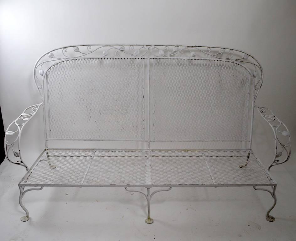 Wrought iron, mesh and floral metal sofa. Cushions included show wear and are probably not original. Metal frame is free of damage. Please view the matching lounge chairs we have listed, if you are interested in more pieces. Measures: Seat height