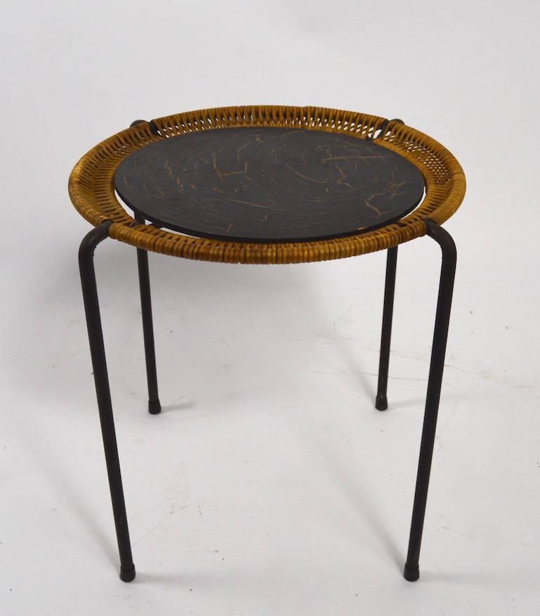 Unusual wrought iron and woven wicker stand with crackle finish Masonite top (original).
The Masonite disk top is removable if you prefer to change that to glass, stone etc.
We have attributed this design to Arthur Umanoff, or perhaps Tempestini.